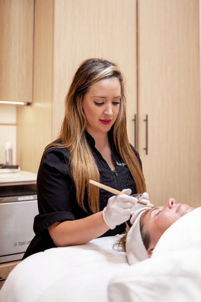 skincare tips for teens: One of our specialists performing a facial.